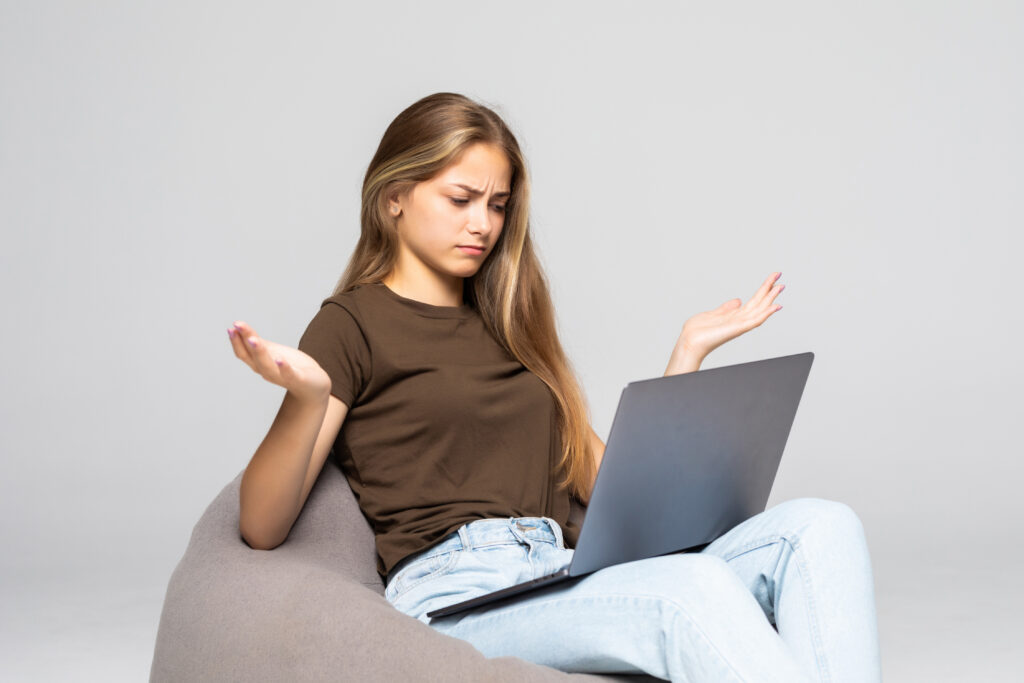 Depressed and frustrated woman working with computer laptop desperate in work. Depression concept. Isolated on white background